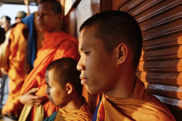 Thailand, Bangkok, young Buddhist monks on a boat crossing the Chao Phraya river at sunset