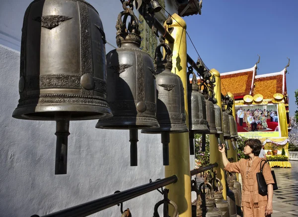 Tailandia, Chiang Mai, Prathat Doi Suthep templo Buddhist, una mujer tailandesa toca las campanas religiosas del templo Buddhist —  Fotos de Stock
