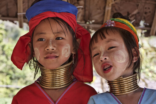 Thailand, Chiang Mai, Karen Long Neck hill tribe village (Kayan Lahwi), Long Neck young girls in traditional costumes. Women put brass rings on their neck when they are 5 or 6 years old and increase t