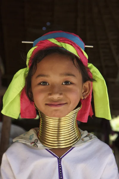 stock image Thailand, Chiang Mai, Karen Long Neck hill tribe village (Kayan Lahwi), Long Neck young girl in traditional costumes. Women put brass rings on their neck when they are 5 or 6 years old and increase th
