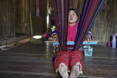 Tayland, chiang mai, karen uzun boyunlu tepe kabile Köyü (kayan lahwi), karen kadın geleneksel kostümleri bir halı yapıyor