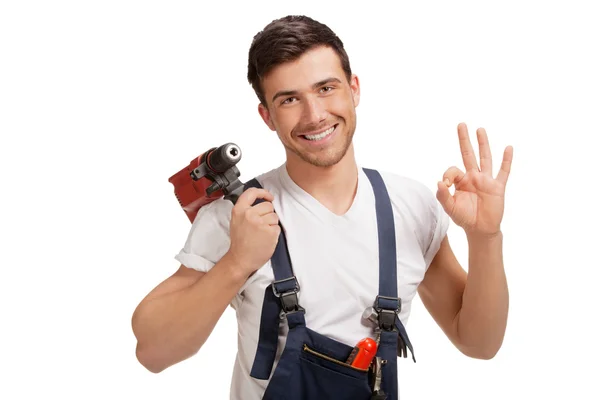 Portrait of happy young handyman with tool — Stock Photo, Image