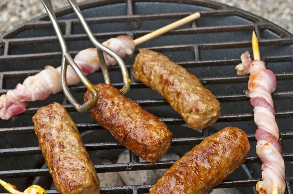 Barbecue with cevapi and ham — Stock Photo, Image