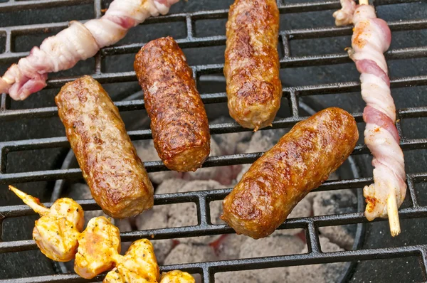 Barbecue with cevapi, meat skewer and ham — Stock Photo, Image