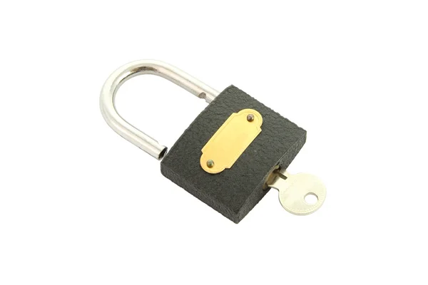 Old black padlock with key close on white background. — Stock Photo, Image