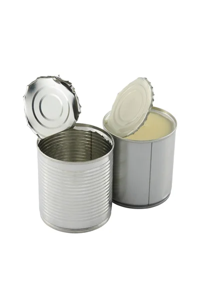 Empty opened in front of full closed sweet milk tin can on white background. — Stock Photo, Image