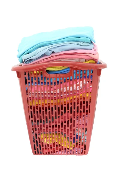 Used cloths in old red plastic basket on white background. — Stock Photo, Image