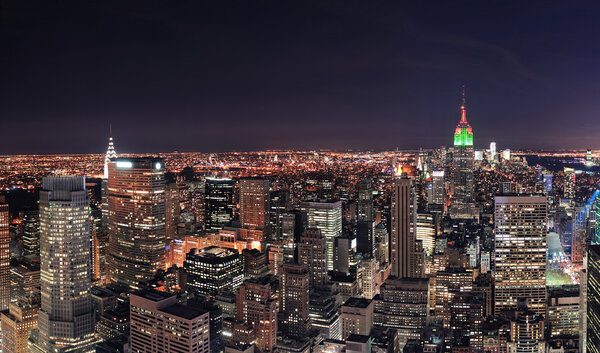New York City Manhattan skyline at night panorama with urban skyscrapers.