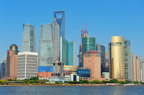 Shanghai urban skyline with blue clear sky over Huangpu River.