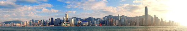 Hong Kong Victoria Harbor in afternoon with urban city skyline and colorful cloud