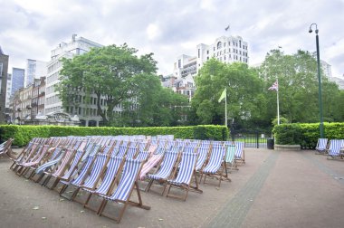 Chairs in city park, London clipart