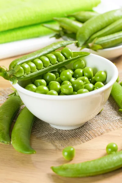 Fresh green peas on the white bowl — Stock Photo, Image
