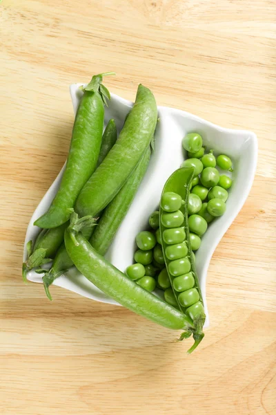 Fresh green peas on the white bowl — Stock Photo, Image