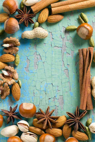 Aroma spices frame. Cinnamon, anise, peanuts, almonds, cardamom, hazelnuts on the vintage wooden surface. — Stock Photo, Image