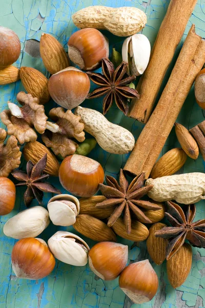 Ароматні спеції. Кориця, аніс, арахіс, мигдаль, кардамон, фундук на старовинній дерев'яній поверхні . — стокове фото