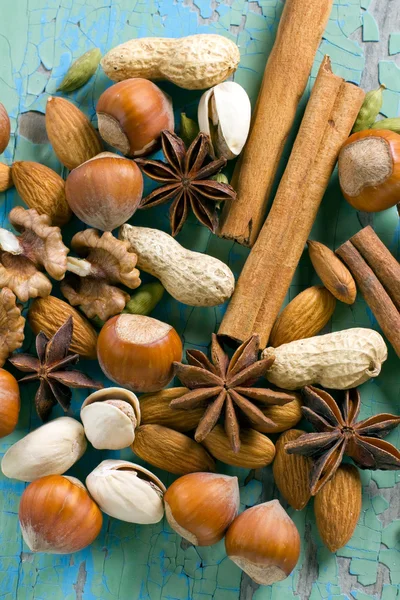 stock image Aroma spices. Cinnamon, anise, peanuts, almonds, cardamom, hazelnuts on the vintage wooden surface.