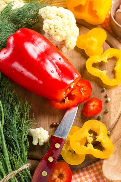 Fresh yellow and red pepper on the wooden board — Stock Photo, Image