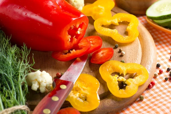 Fresh yellow and red pepper on the wooden board — Stock Photo, Image