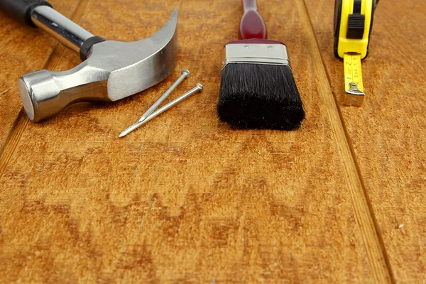 Assorted work tools on wooden surface — Stock Photo, Image