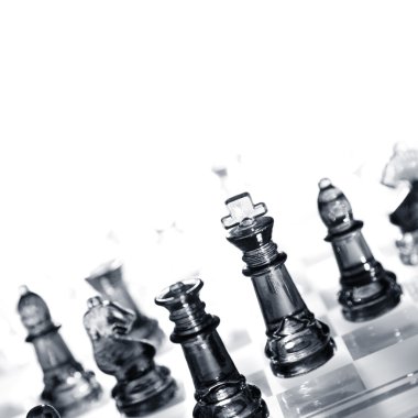 Closeup of glass chess pieces. Copy space clipart