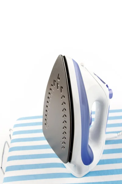 New iron on striped ironing board — Stockfoto