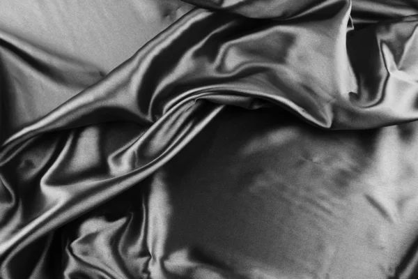 Primer plano de pliegues en tela de seda negra — Foto de Stock