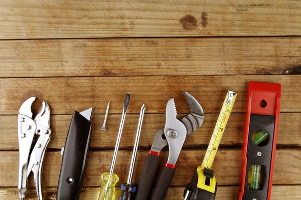 Assorted work tools on wood — Stock Photo, Image