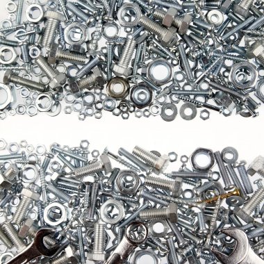 Wrenches, nuts and bolts on plain background clipart