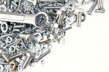 Wrench, nuts and bolts on plain background clipart