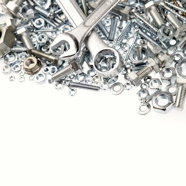 Wrenches, nuts and bolts on plain background — Stock Photo, Image