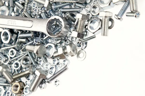 Wrench, nuts and bolts on plain background — Stock Photo, Image
