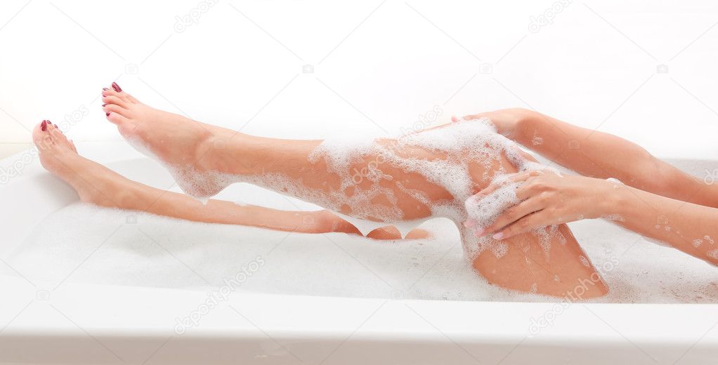 Stock photography ▻ Legs of beautiful young asian female in bath tube with ...