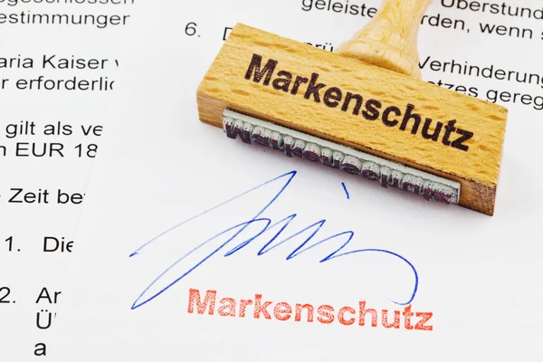 Wood stamp on the document: brand protection — Stock Photo, Image