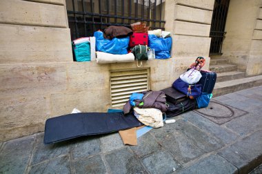 Paris, france. a homeless person sleeping clipart