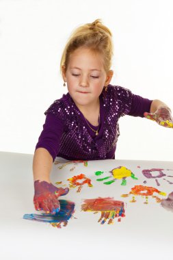 Child painting with finger paints clipart