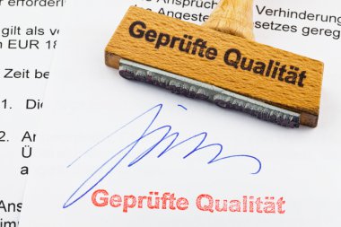 Wood stamp on the document: proven quality clipart