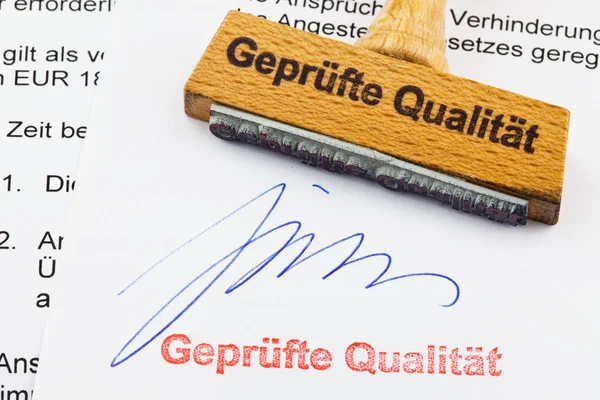 Wood stamp on the document: proven quality — Stock Photo, Image