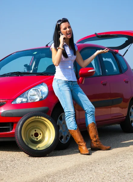 Woman with a flat tire on car — Stock Photo, Image