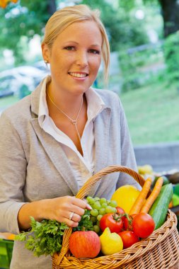 Woman at the fruit market with shopping basket clipart