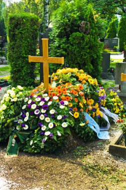 A fresh grave in a cemetery clipart