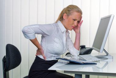 Women in the office with back pain clipart