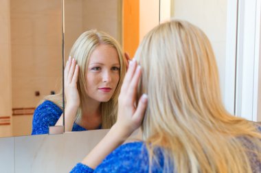 Woman brushing her hair clipart