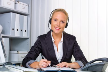 Friendly woman with a headset in customer service clipart
