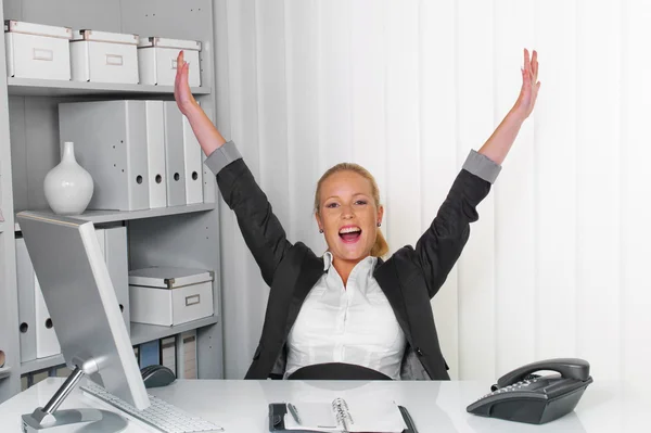 Successful young woman in an office Stock Photo