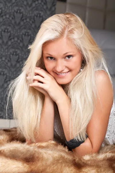 Young pretty blond girl on fur — Stock Photo, Image