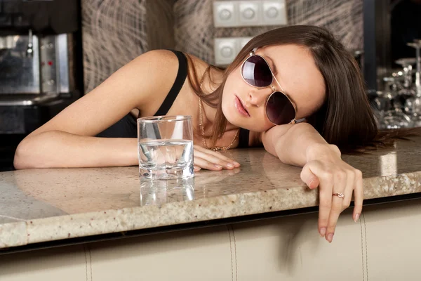 Cute brunette girl at a bar table — Stock Photo, Image