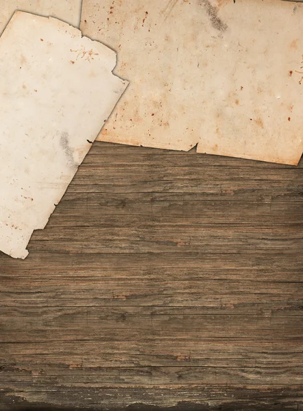 Faded paper sheets on a wooden background — Stock Photo, Image