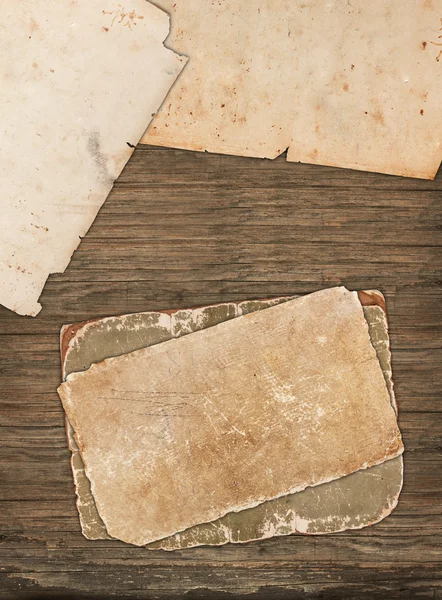 Papeles viejos dañados sobre un fondo de madera —  Fotos de Stock