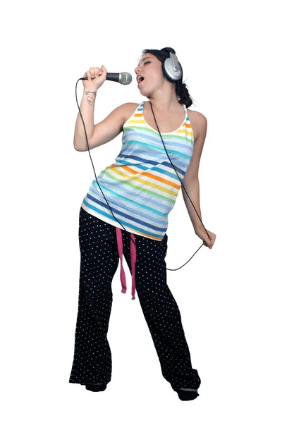 Morena atraente com fones de ouvido e um microfone (1 ) — Fotografia de Stock