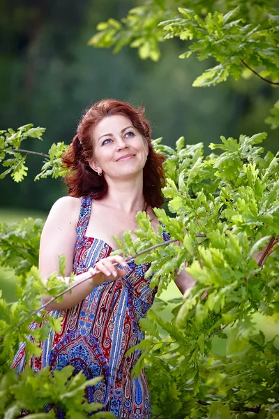 Woman with oak branches — Stock Photo, Image